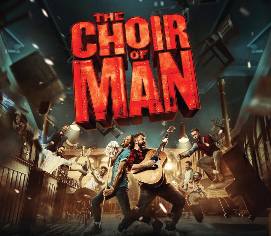 Promotional image for “The Choir of Man,” showing two men performing in a bar scene, one with a mop and one with a guitar, alongside the show’s bold red lettering.